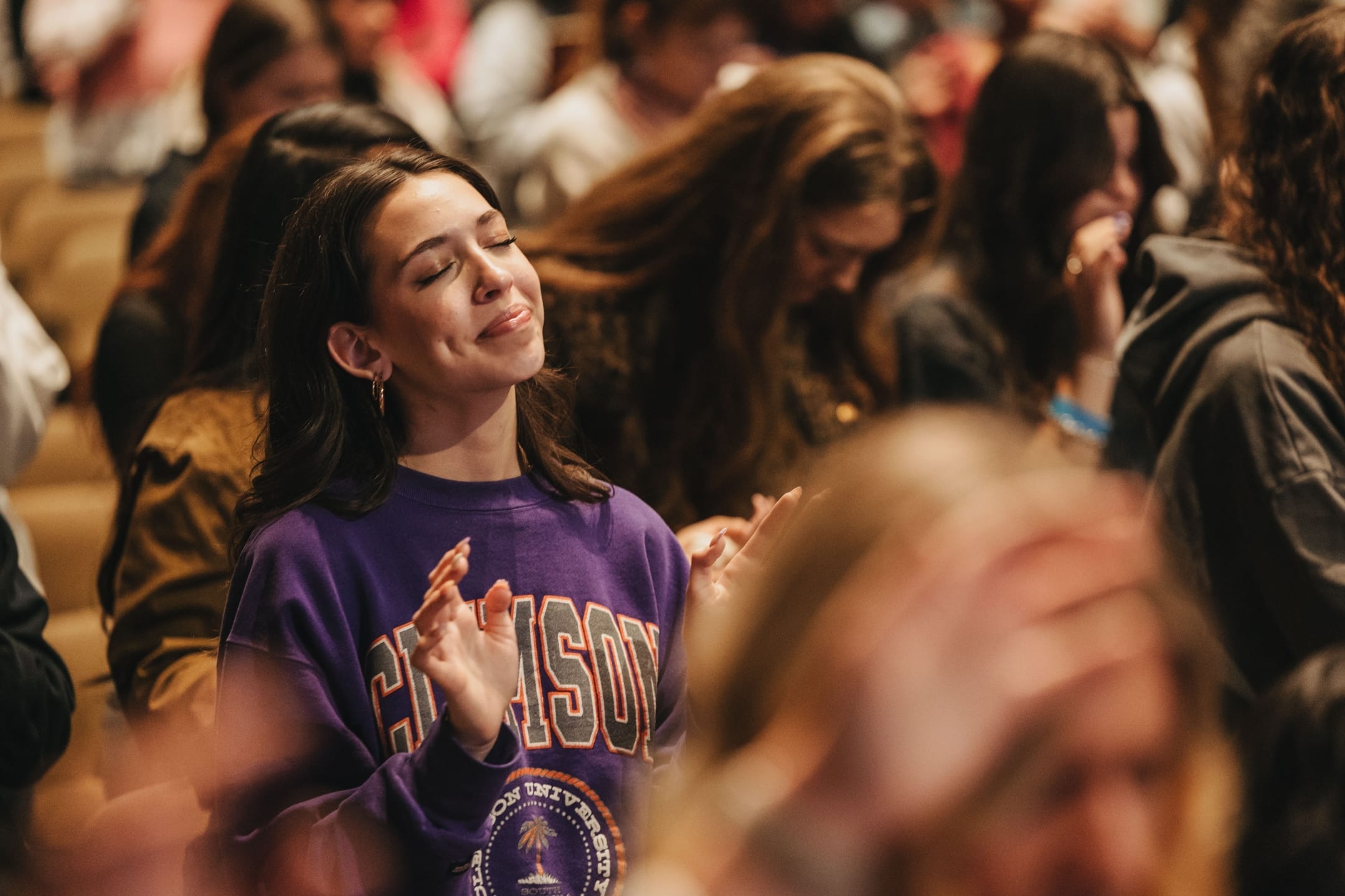 Womain smiling, eyes closed in worship